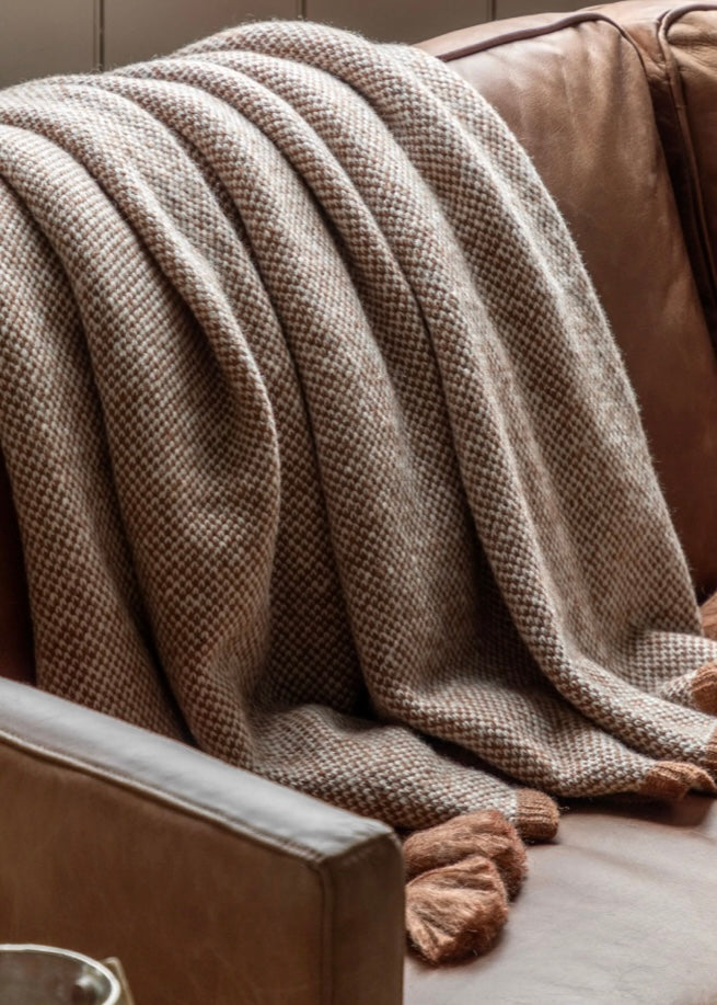Soft chunky knit with tassel detailing. Rust.